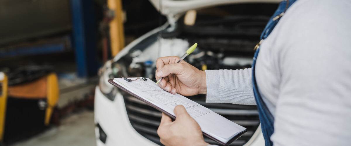 Hand young man mechanic holding clipboard checklist car service center repair 1200x500